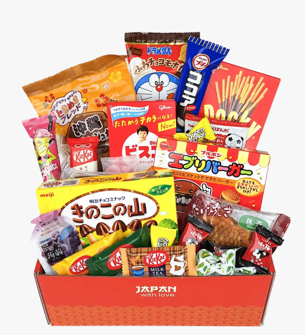Red cardboard box labeled ’japan with love’ filled with assorted japanese snacks.