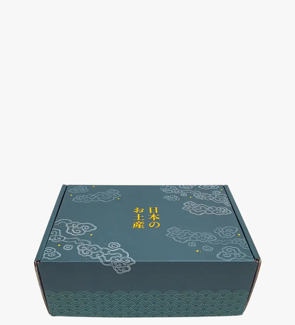 Teal cardboard gift box adorned with white cloud and wave patterns, featuring gold japanese characters.