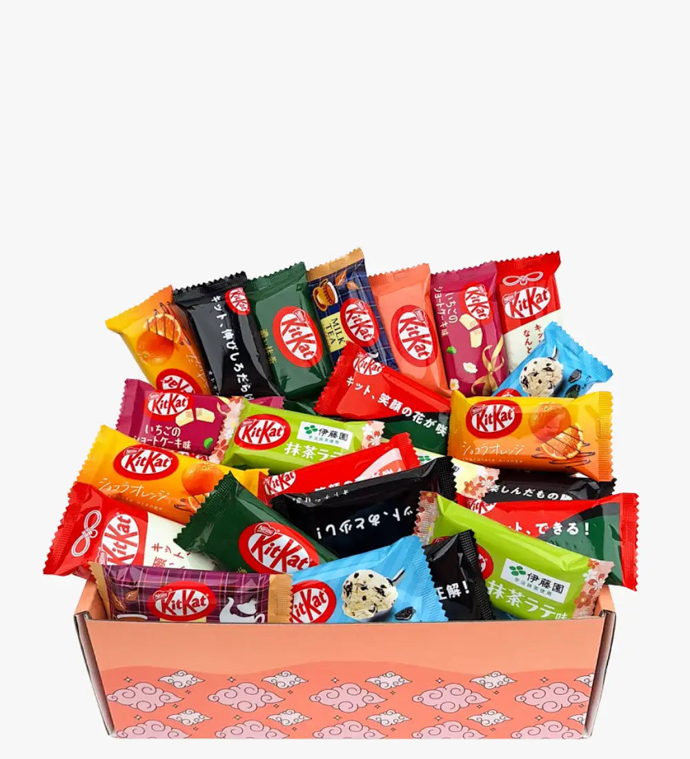 A vibrant assortment of kitkat chocolate bars in colorful, assorted wrappers nestled inside a pink patterned gift box.